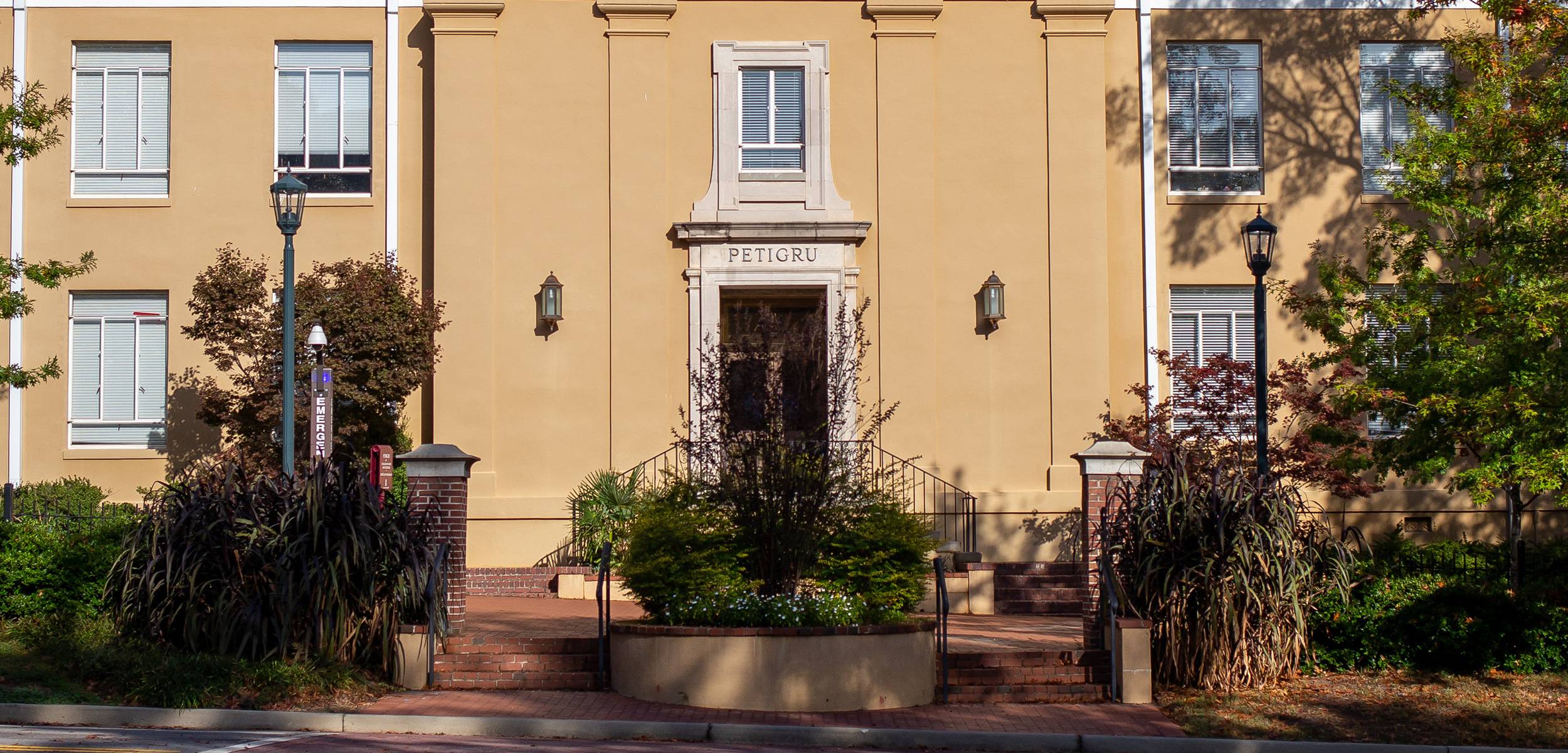 Exterior view of Petigru College building at the University of South Carolina with text overlay reading ‘The McCausland College of Arts and Sciences is where curiosity meets impact.