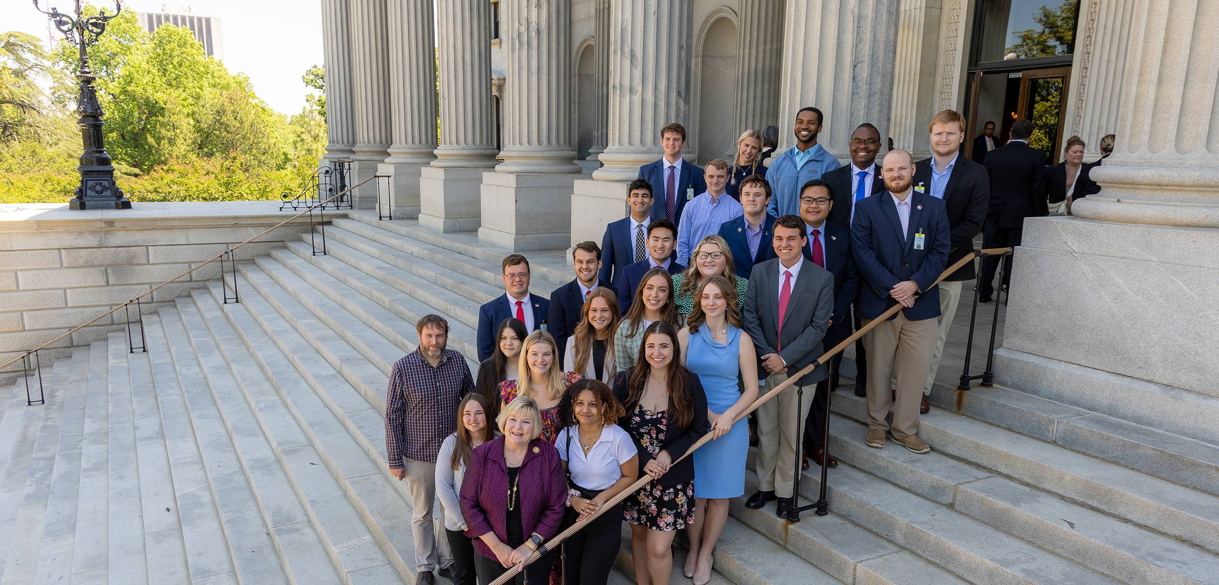 Students and faculty pose on the steps of the South Carolina State House.