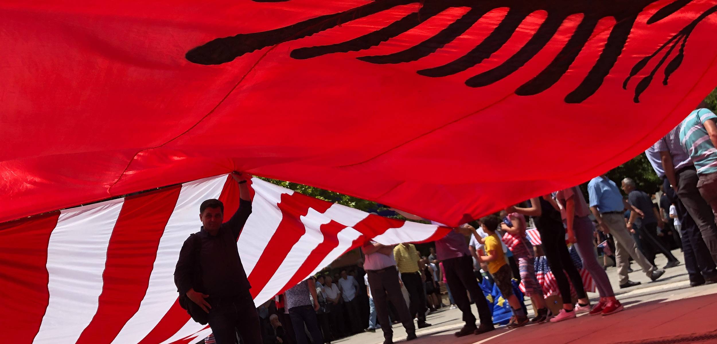 USC students and faculty posing together in a historic European town square during a study-abroad program.