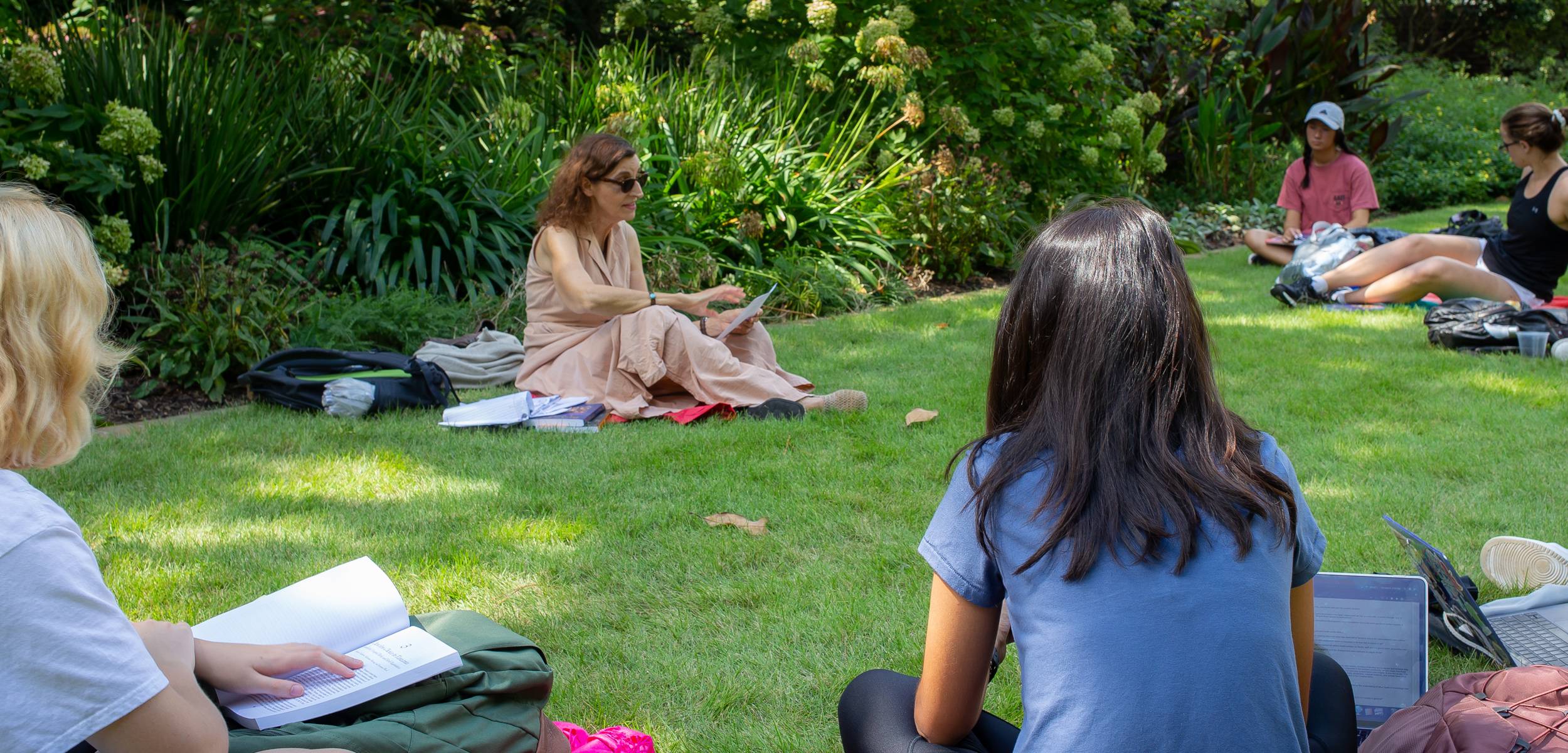 students on green grass in an outside class
