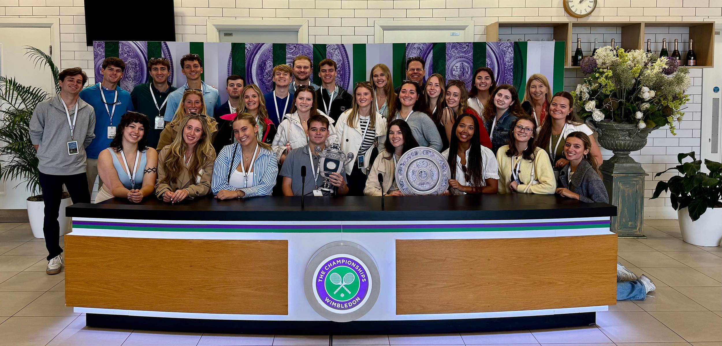 students holding Wimbledon trophies
