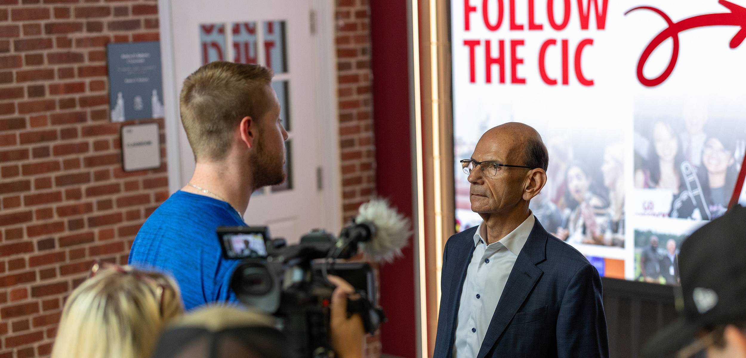 the inside of the j-school with students interviewing Paul Finebaum
