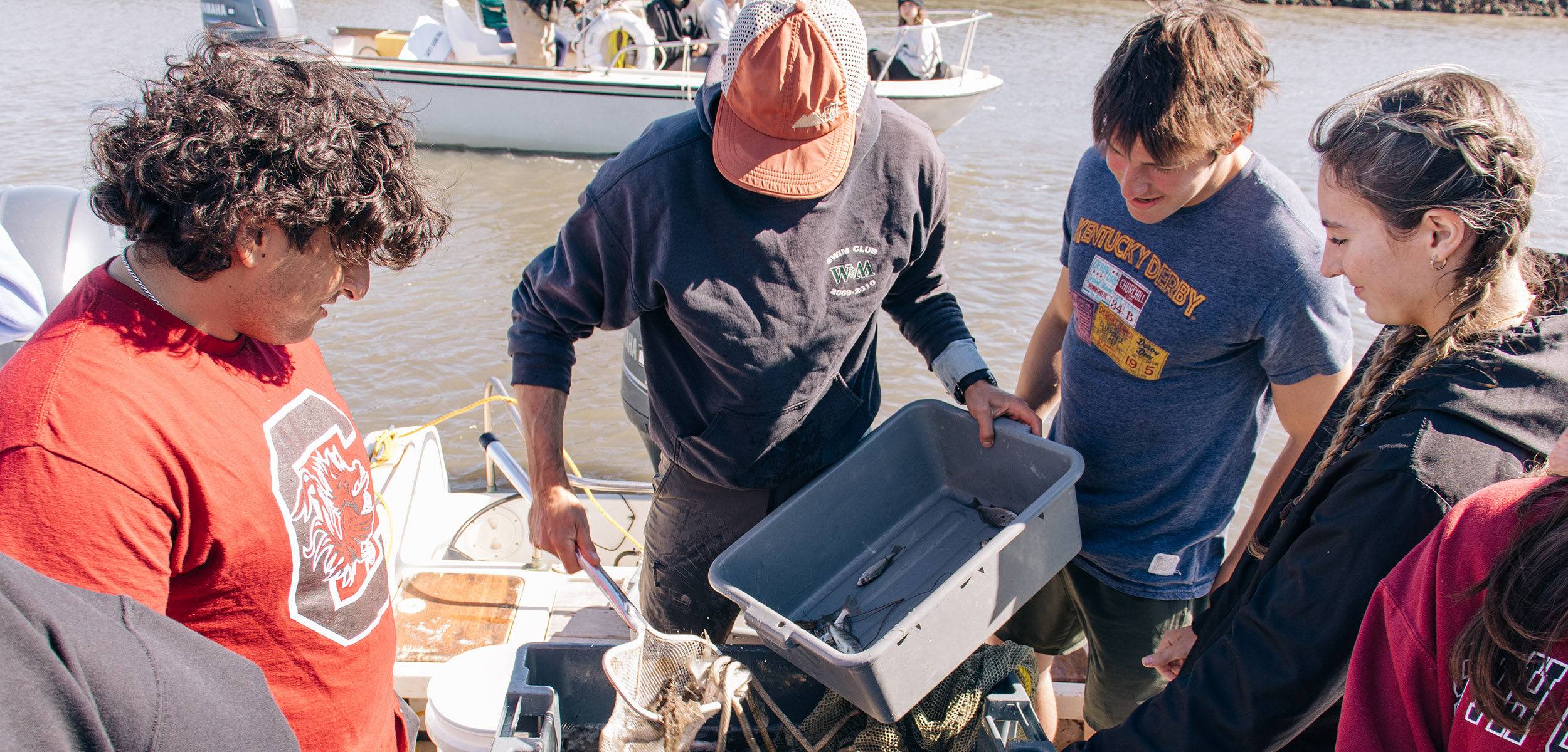 Professor instructing a group of students on a boat