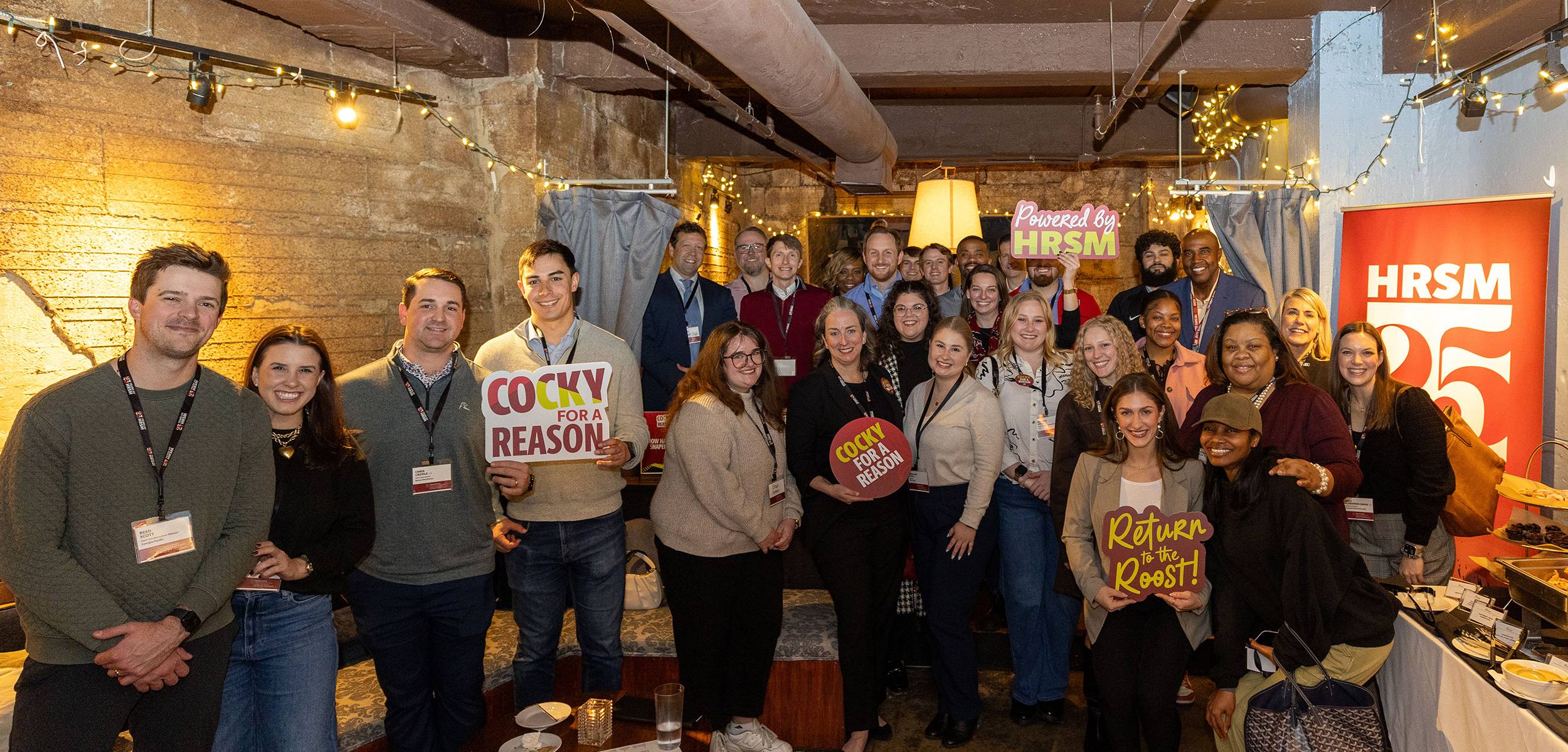 HRSM alumni and staff pose for a photo during a reconnect event