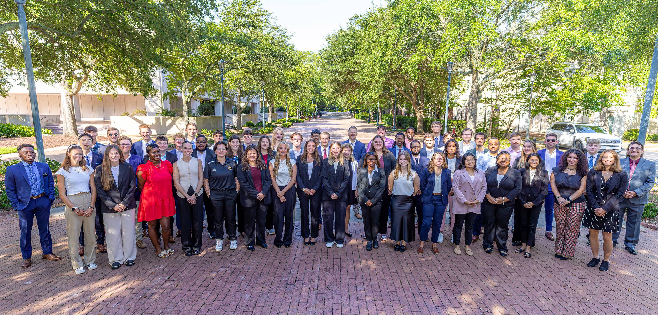 Group photo of Master of Sport Entertainment students on a sunny day