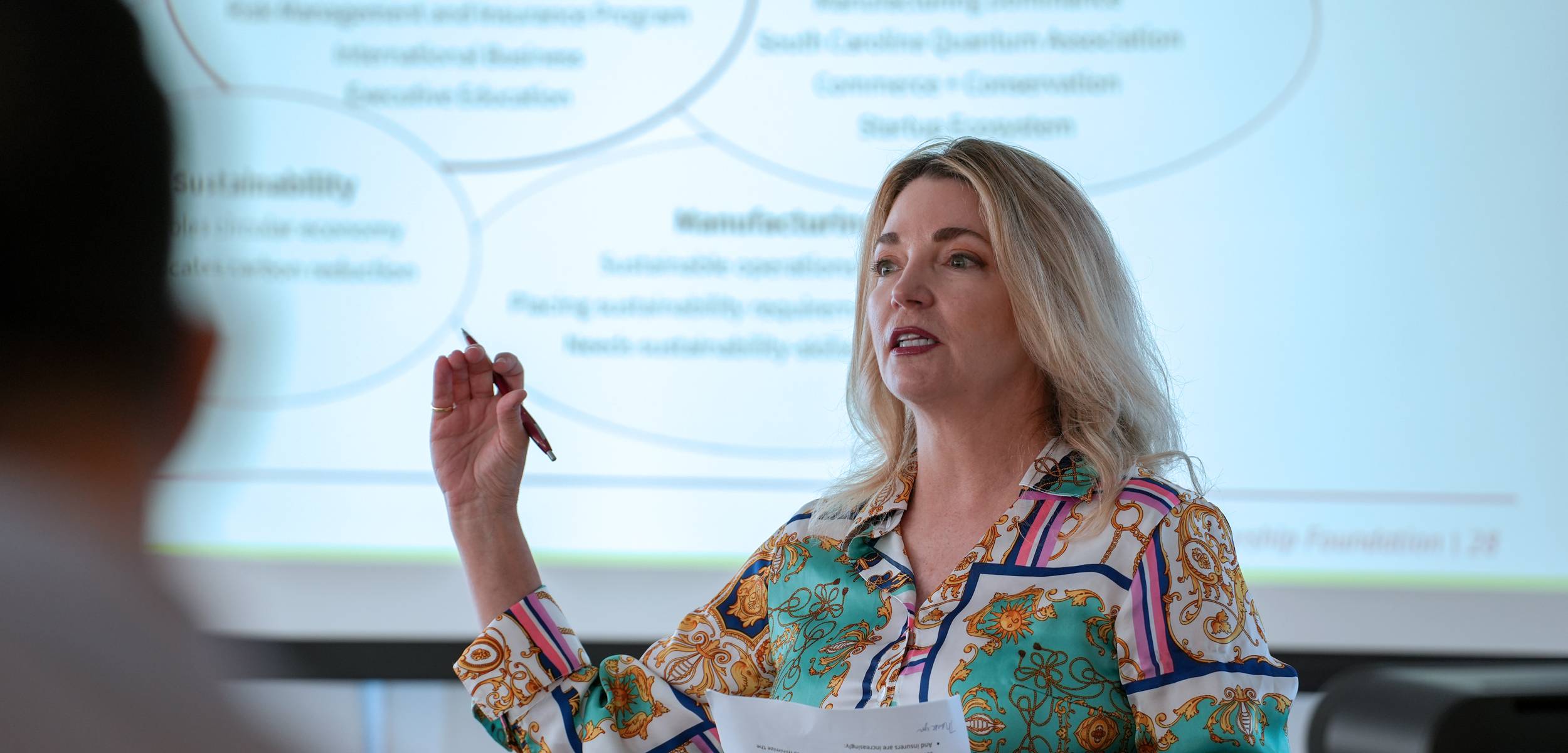 female professor speaking at a sustainability roundtable