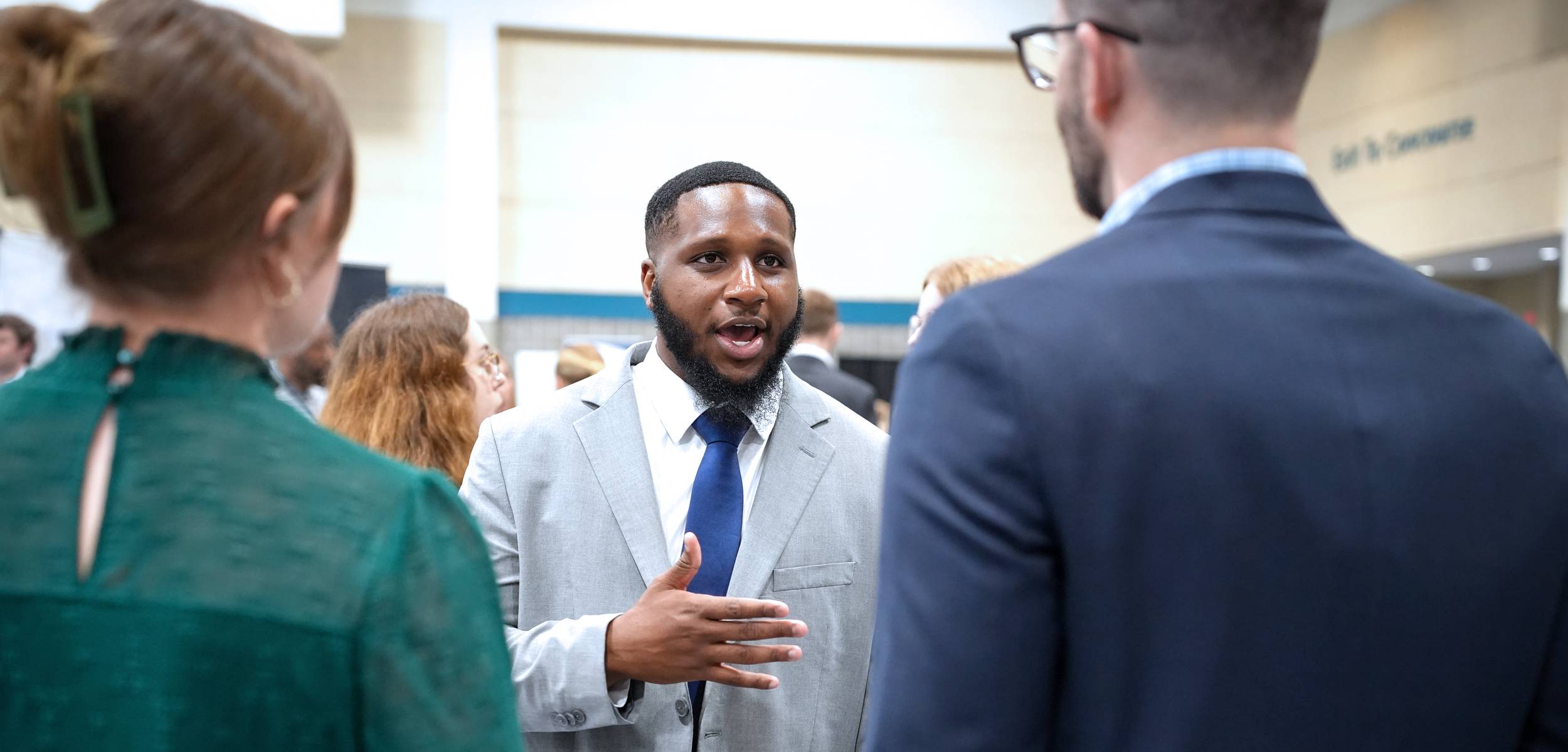 Students talking to company recruiter at Business EXPO.