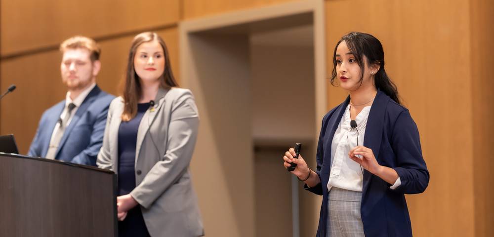 Students presenting on stage
