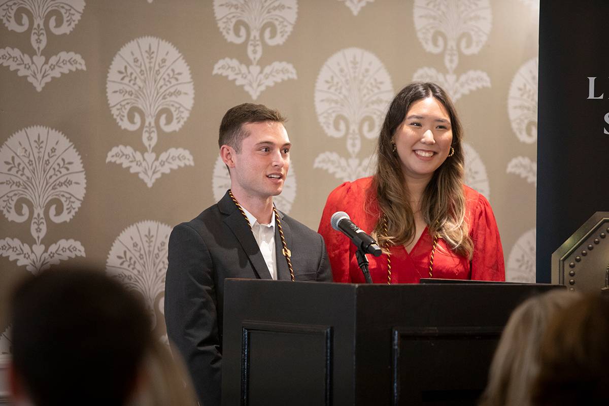 Two students speaking at a podium
