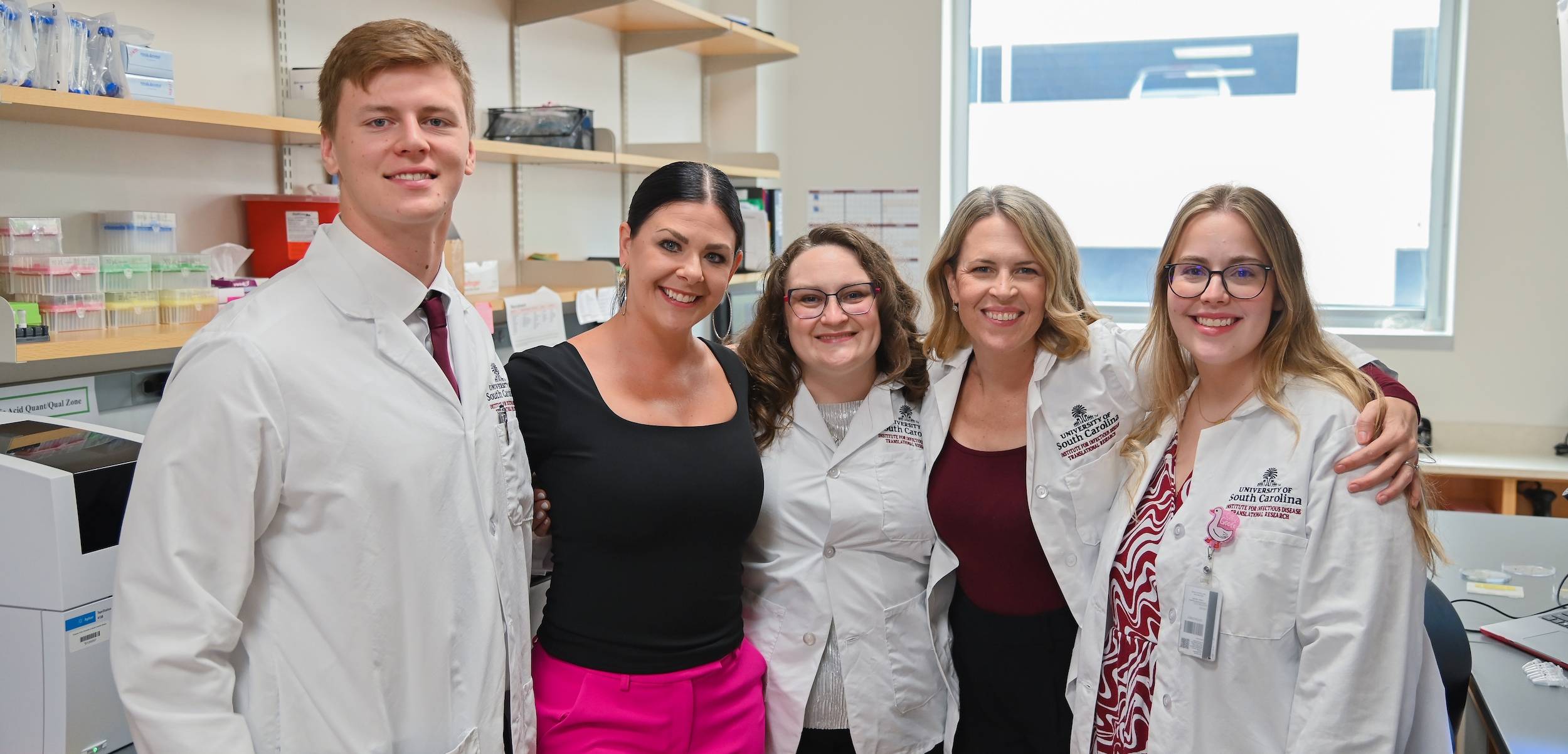 Students smiling in a lab