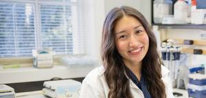 Hannah brennen in the lab smiling