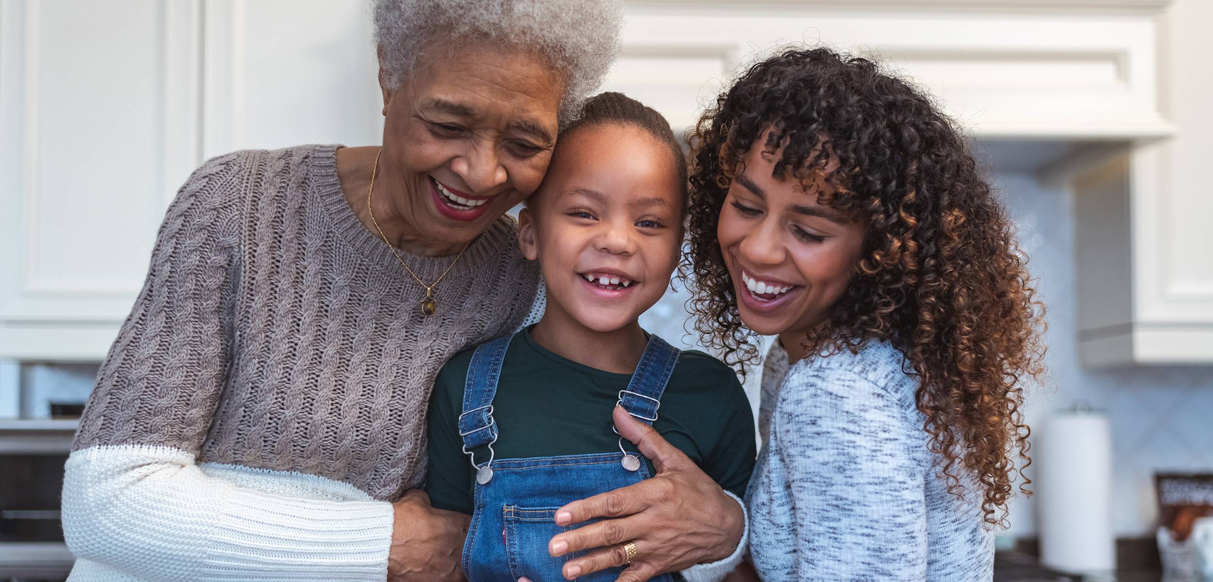 Grandmother, mother ands daughter smiling